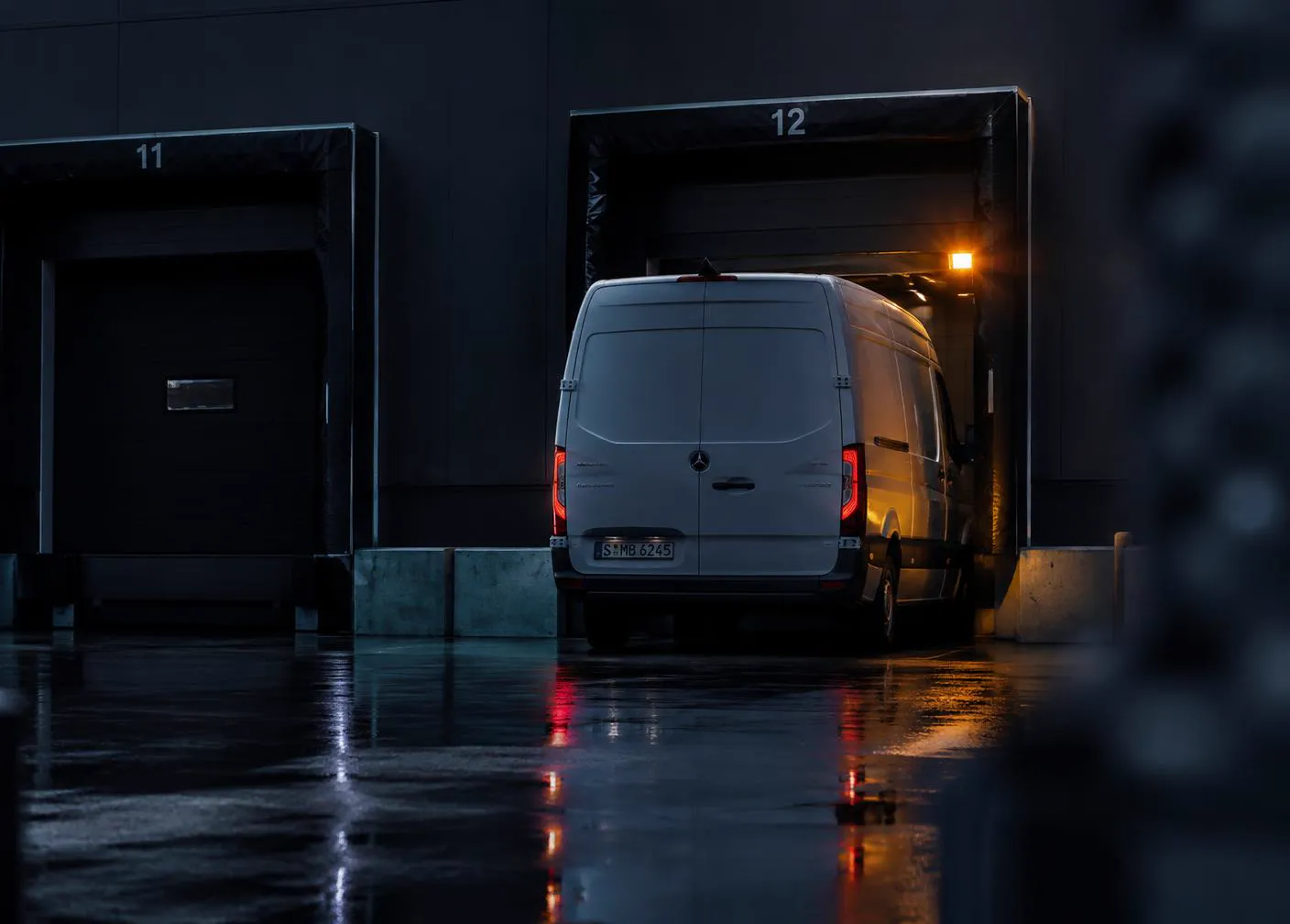 White cargo van loading at a corporate loading dock at dusk in Oklahoma